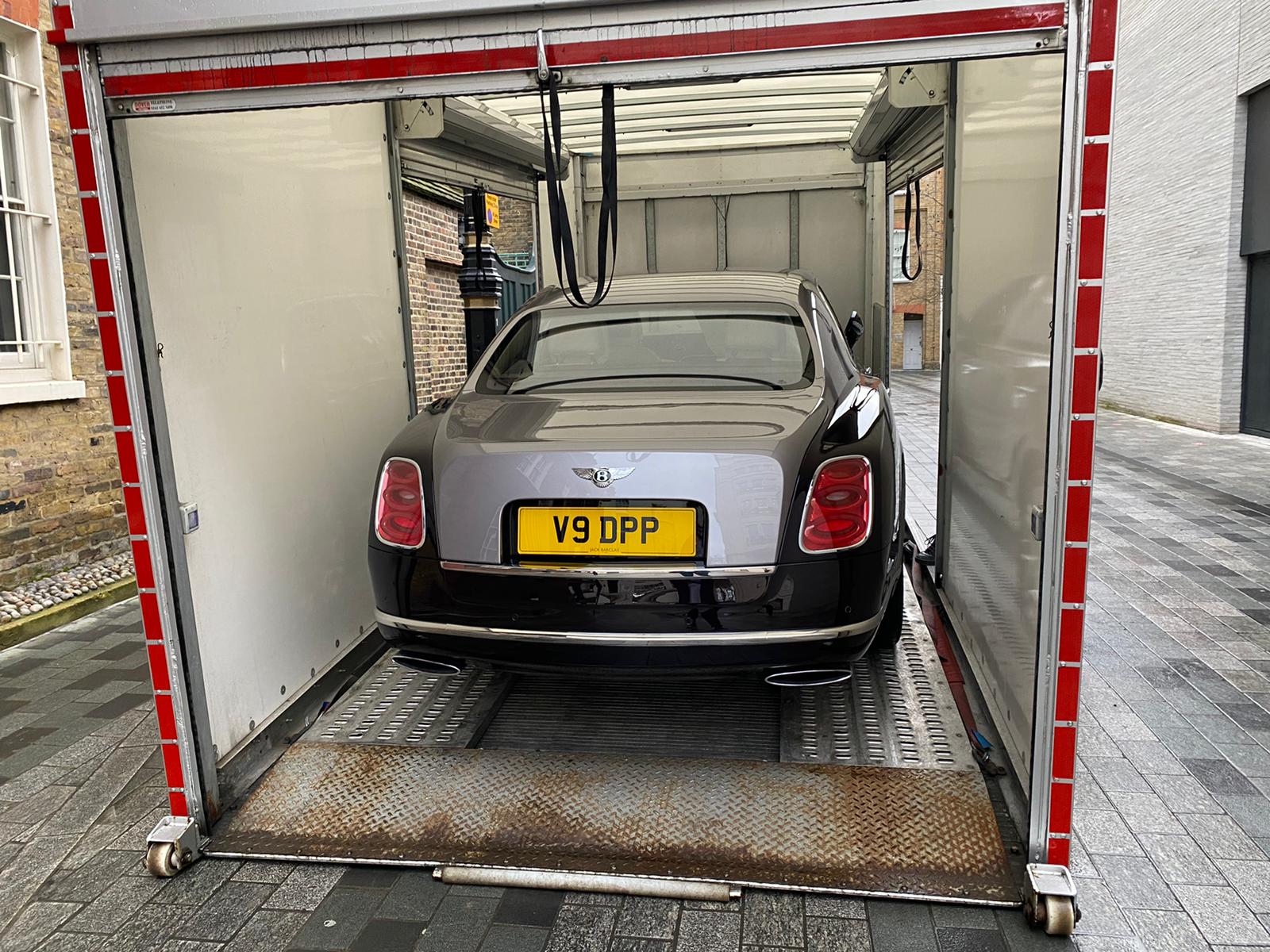 Bentley secured inside a CPS Transport enclosed vehicle transporter